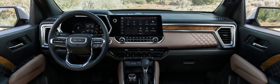 The Stylish Front Interior with the Steering Wheel and Infotainment System on the GMC Canyon Denali