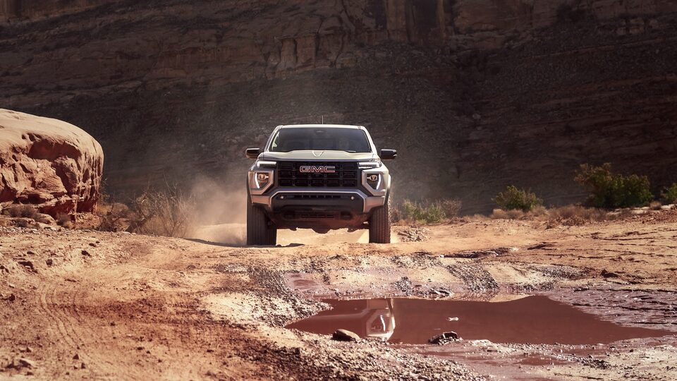 The GMC Canyon Driving In the Desert Head-On Kicking up Dirt