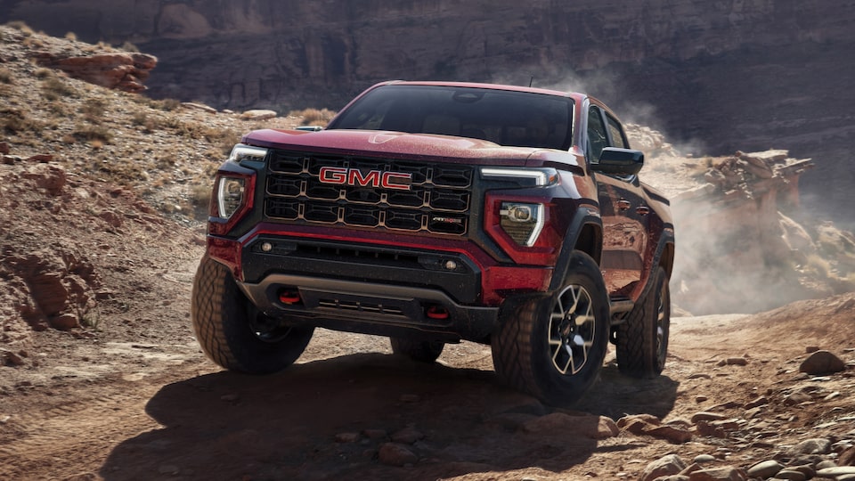The Powerful GMC Canyon AT4X Driving Uphill Kicking Up Dirt