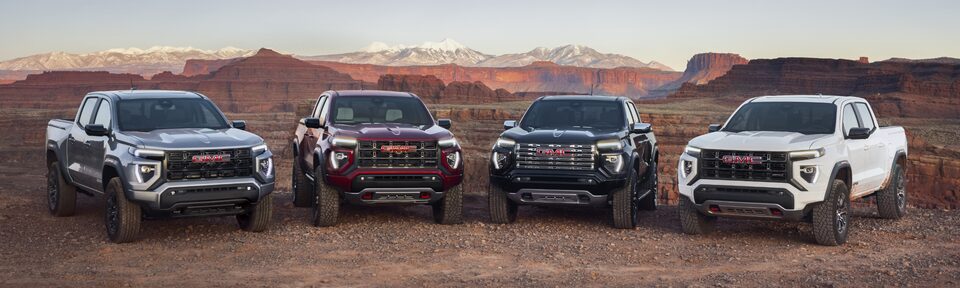 The Lineup of GMC Canyon Trims Parked in a line in a Desert Valley