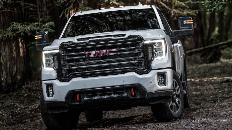 The GMC Sierra HD AT4 Driving Off-Road Through Trees