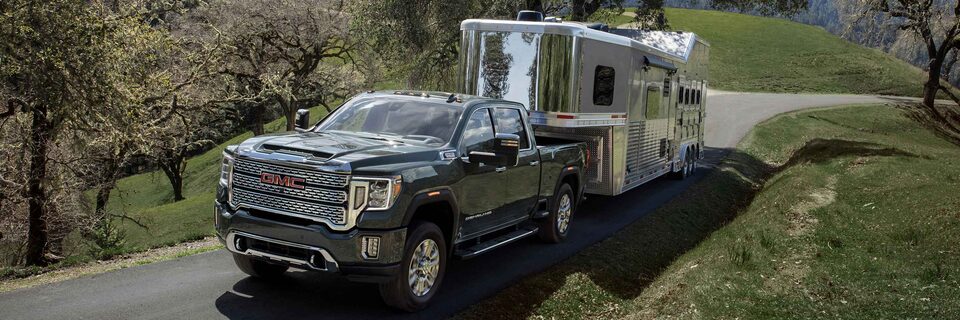 The Powerful GMC Sierra HD Denali Towing a Trailer On-Road Uphill