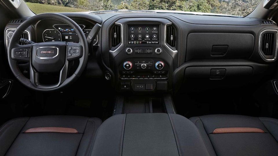 The Stitched Leather Interior, Steering Wheel, and Infotainment System on the GMC Sierra HD 