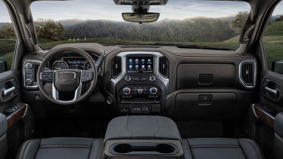 The Stylish Interior with Steering Wheel, Heads-Up Display, and Infotainment System on the GMC Sierra HD