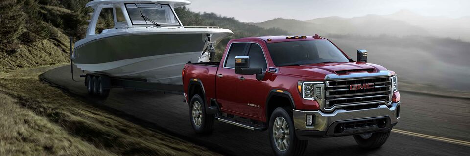 The GMC Sierra HD SLT Driving On-Road Towing a Boat
