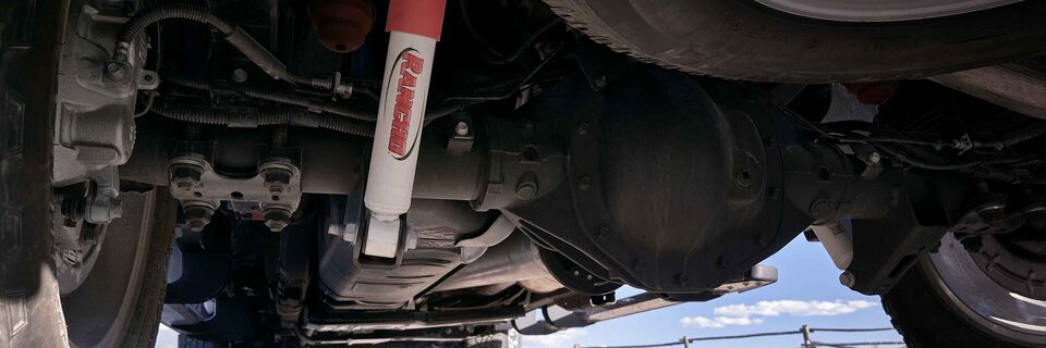 Closeup on the Off-Road Suspension With Rancho Shocks and Skid Plates on the GMC Sierra HD