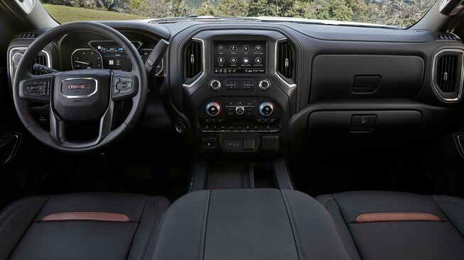 The Jet Black Interior With Steering Wheel, Heads-Up Display, and Infotainment System on the GMC Sierra HD AT4