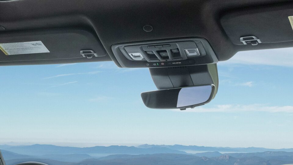 The Rear View Mirror on the GMC Sierra LD with a Stunning Backdrop of the Ocean