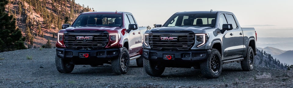 The Sierra 1500 AT4X Kicking Up Dirt as It Climbs an Off-Road Incline