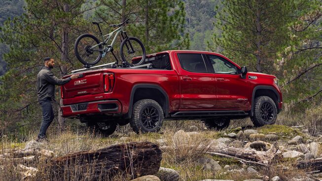 A Man Stops Loading His Bike on His Sierra AT4 to Enjoy the View of the Forest
