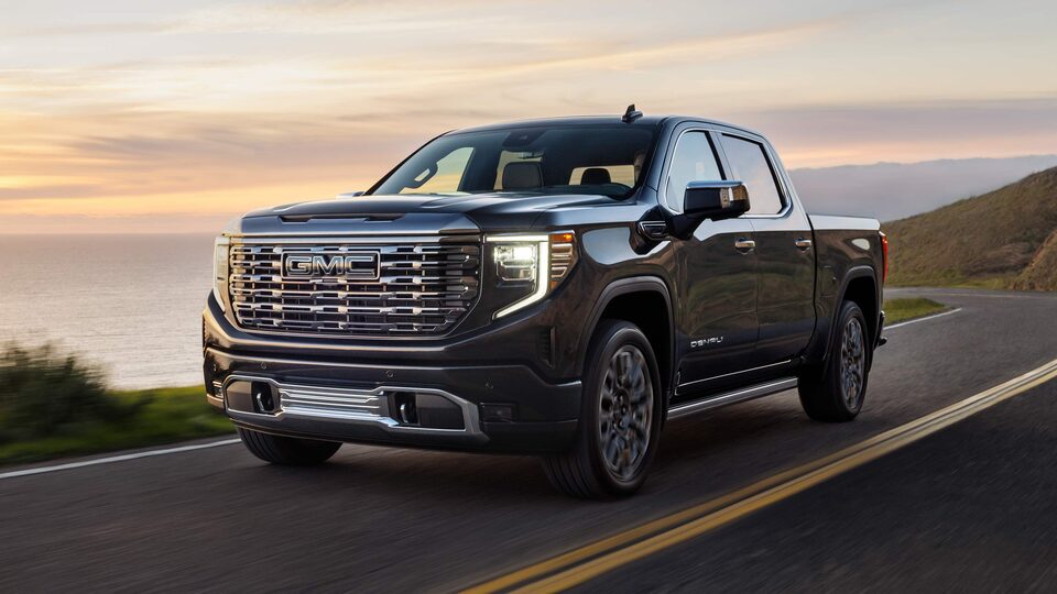 The New GMC Sierra LD Driving On-Road During a Sunset