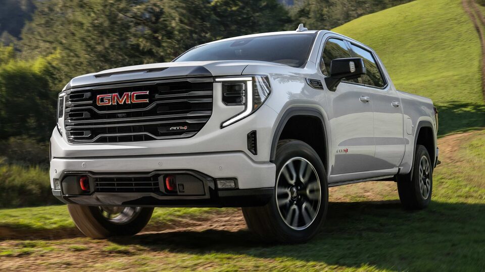 The Summit White GMC Sierra LD Parked Off-Road on Grass