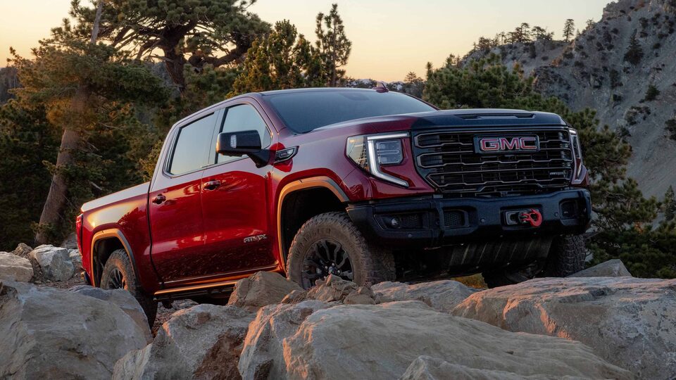 The Red GMC Sierra Driving Uphill on Rocks