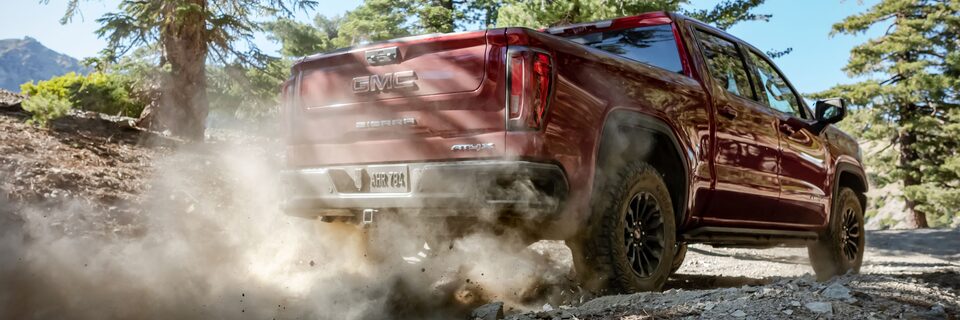 The Sierra AT4X Kicking Up Dirt on an Off-Road Trail