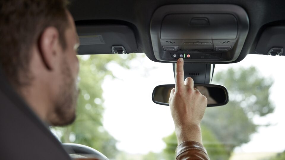 A Man Clicking a button inside his GMC Sierra LD