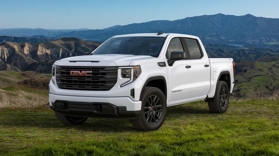 The GMC Sierra Parked on a Grass Field Near a Steep Drop