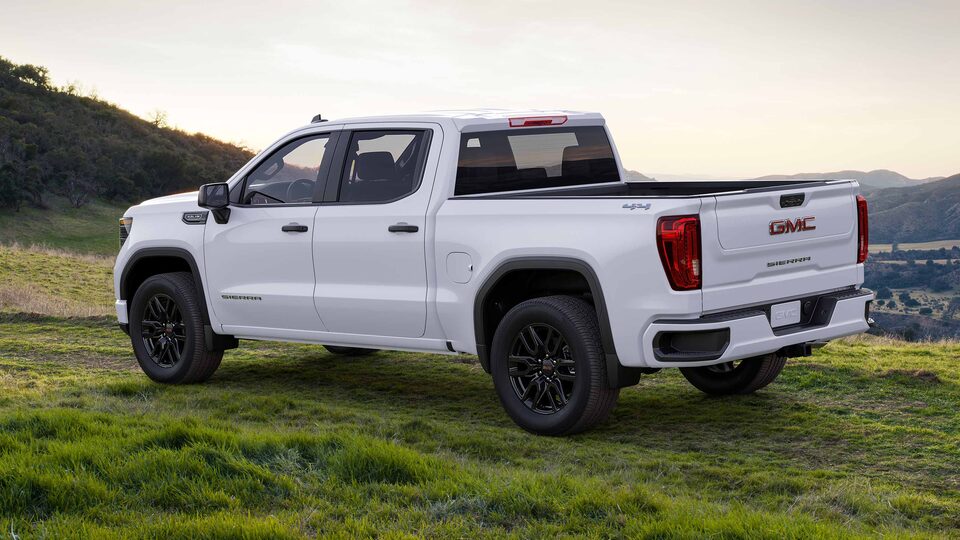The GMC Sierra Parked on a Grass Field Near a Steep Drop