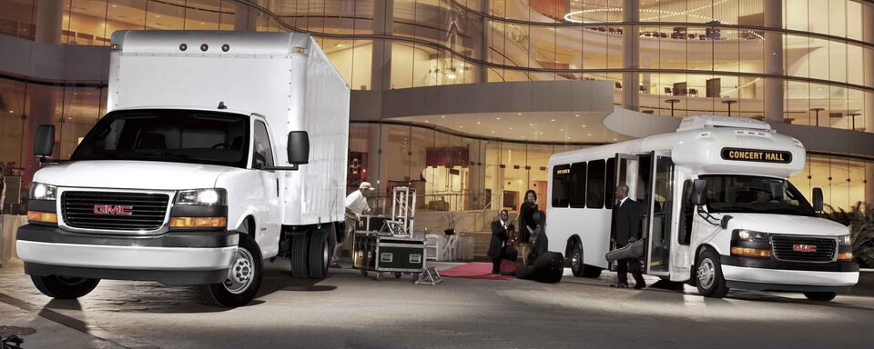 2023 GMC Savana Cutaway and Passenger Vans Outside Concert Hall