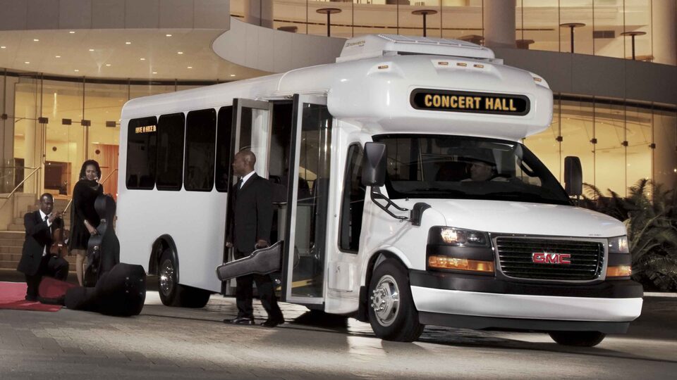 2023 GMC Savana Passenger Van with Band Members Outside