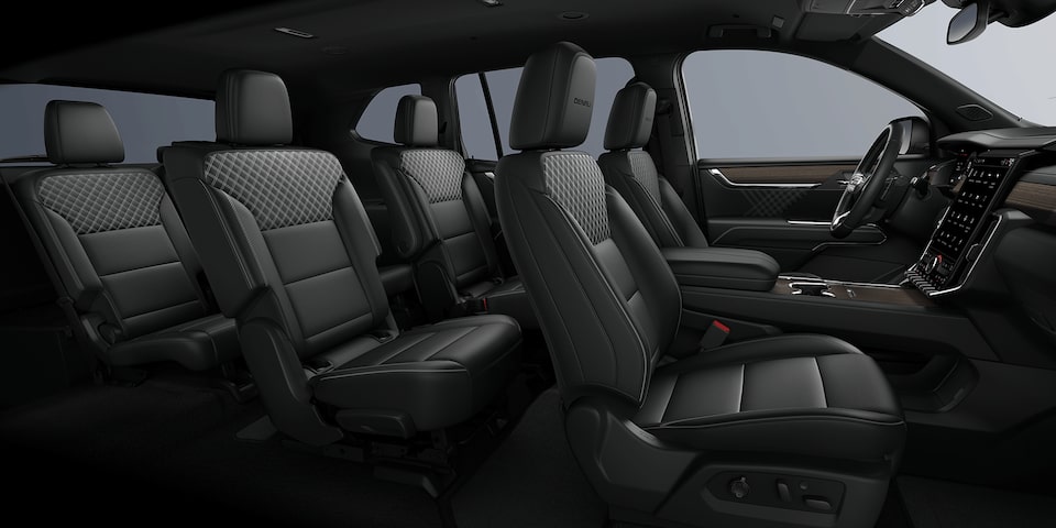 Wide Side View of the 3 Row Black Seating in a 2024 GMC Acadia Mid-Size SUV