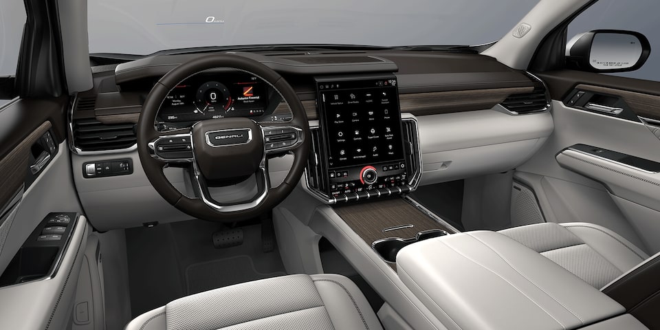 Wide View of the Front Row Seating, Steering Wheel, and Dashboard in a 2024 GMC Acadia Mid-Size SUV