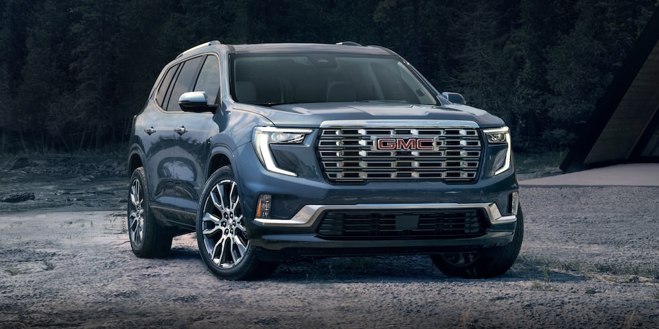 Front Three-Quarters View of a 2024 GMC Acadia Denali SUV With Water Nearby