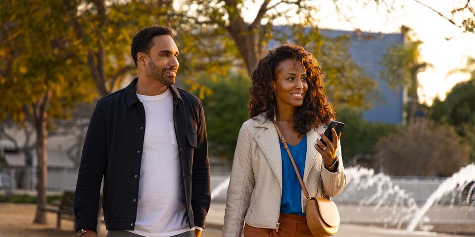 A Happy Couple Walking through the Park