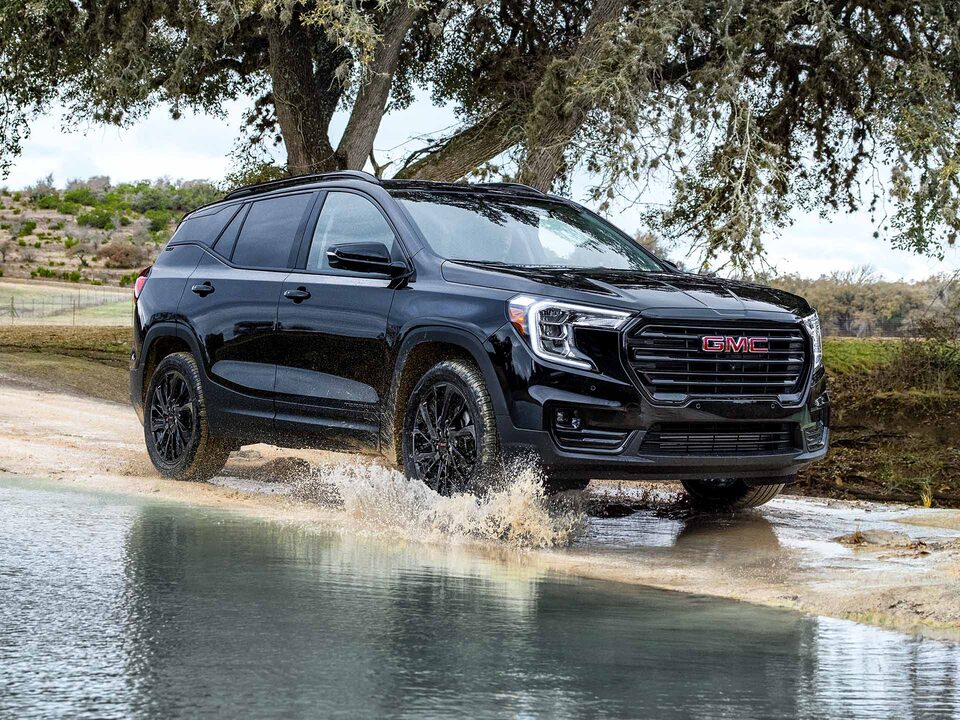 A GMC Terrain Driving Through Mud and Water
