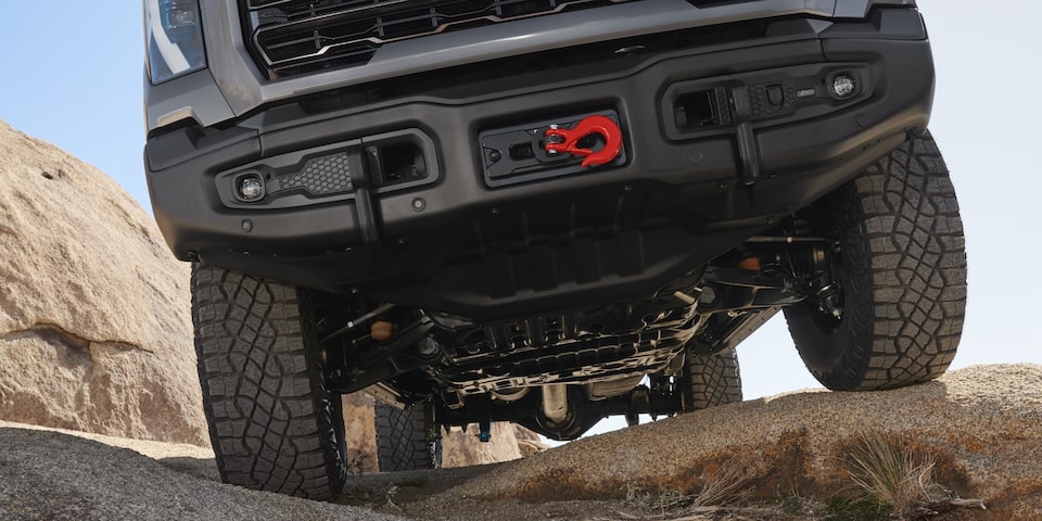 An Undercarriage Shot of the Sierra HD AT4 Showcasing Its Skid Plate and Red Tow Hook