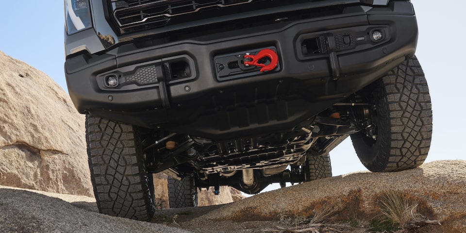 An Undercarriage Shot of the Sierra HD AT4 Showcasing Its Skid Plate and Red Tow Hook