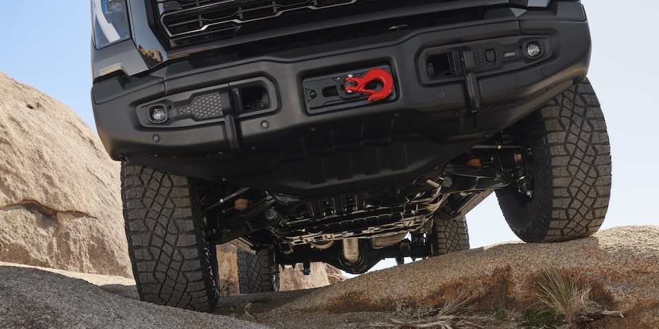 An Undercarriage Shot of the Sierra HD AT4 Showcasing Its Skid Plate and Red Tow Hook