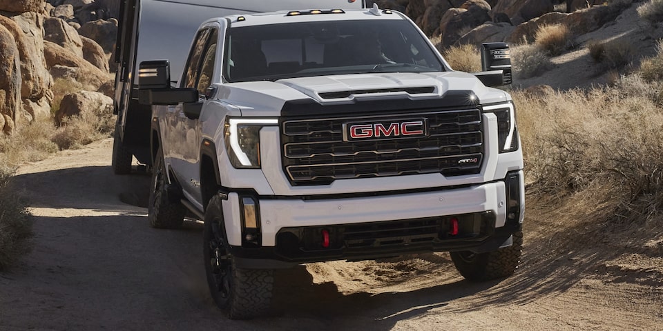 The Sierra HD AT4 Towing a Camper Up an Off-Road Mountain Incline