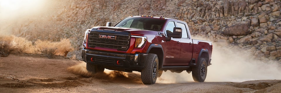 The Sierra HD AT4 Kicking Up Dirt on an Off-Road Mountain Trail