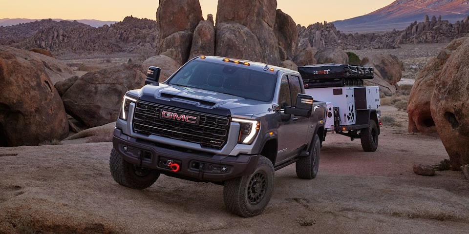  The Sierra HD AT4 Towing a Camper Through a Narrow Mountain Road Incline