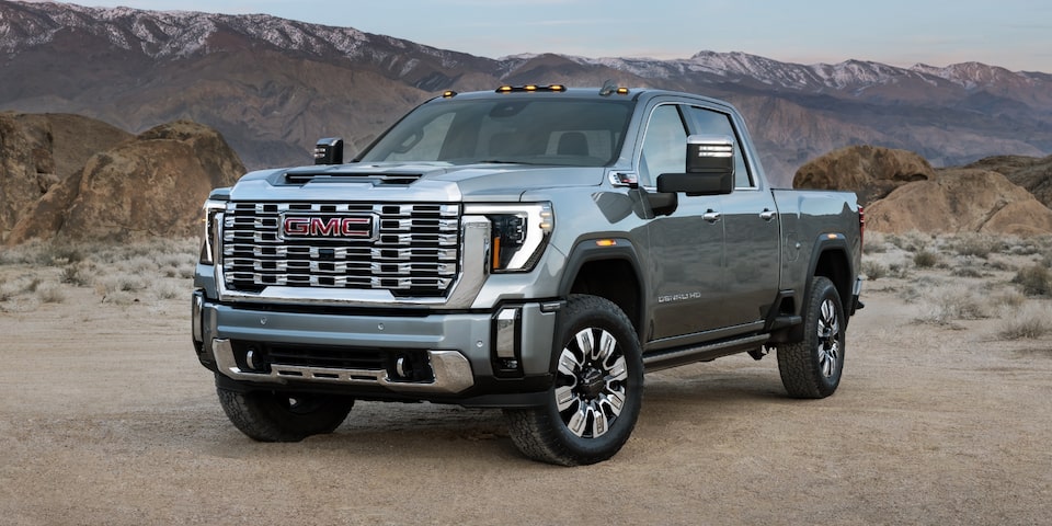 The Imposing Sierra HD Denali Parked in the Desert with a Mountain Chain in the Distance