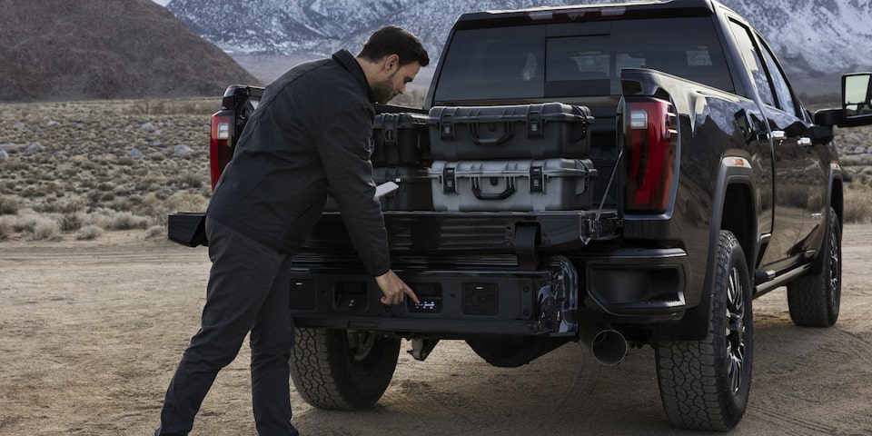  A Man Activating His Multipro Tailgate to Better Access His Cargo While Out in the Mountains