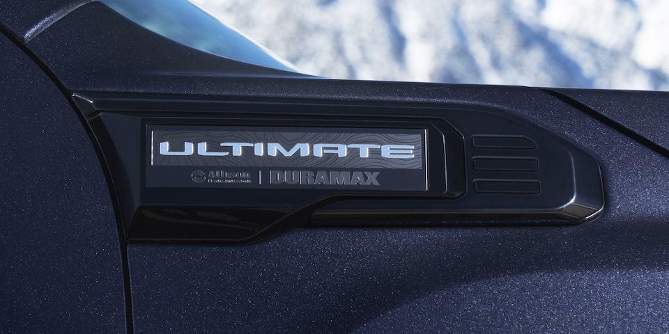 The Exterior Ultimate Badging of the Sierra HD Denali with a View of the Sky in the Distance