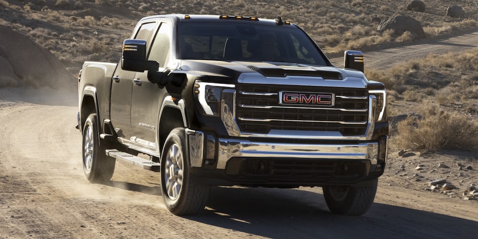 The GMC Sierra HD Pro Driving Off-Road Kicking Up Dirt