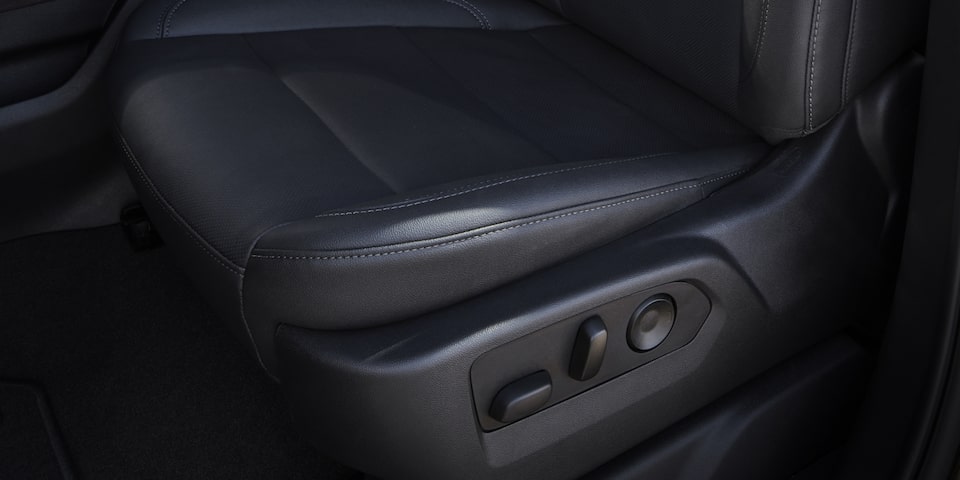 Close-Up on the Stitched Leather Interior Seating and Seat Adjustments on the GMC Sierra HD