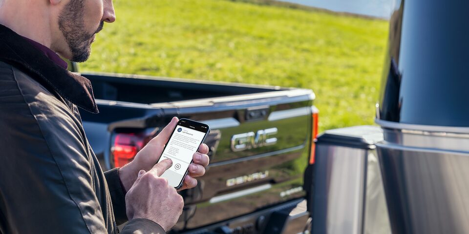 Image of Man Viewing Trailering Functions in the myGMC Mobile App