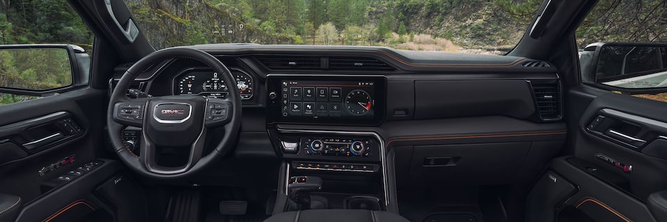 An Interior View of the Front Seats, Steering Wheel, and More on the GMC Sierra 1500 AT4