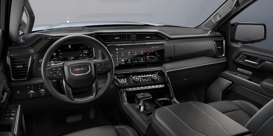 Wide View of the Front Row Seating, Steering Wheel, and Dashboard in a 2024 GMC Acadia Mid-Size SUV