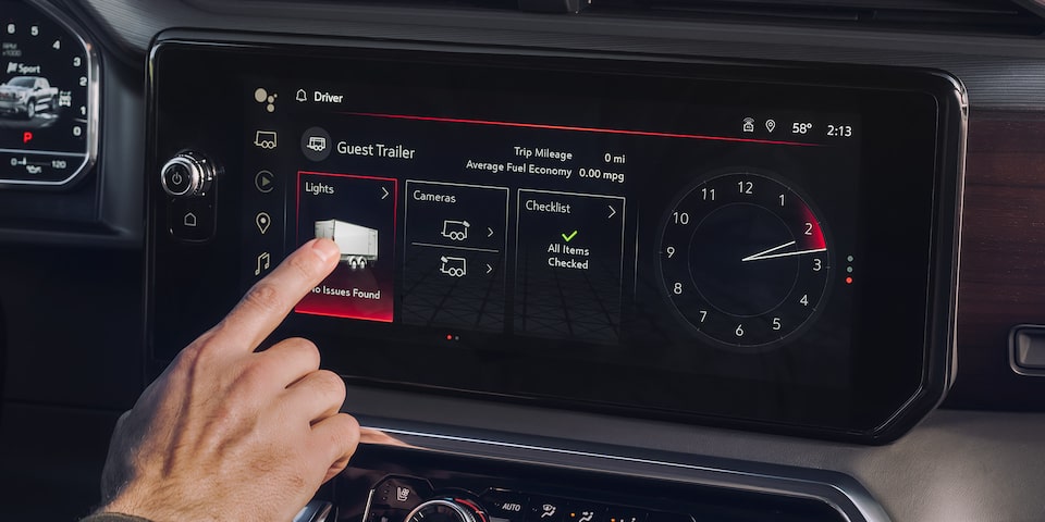 A Person Utilizing The GMC Sierra LD Infotainment System