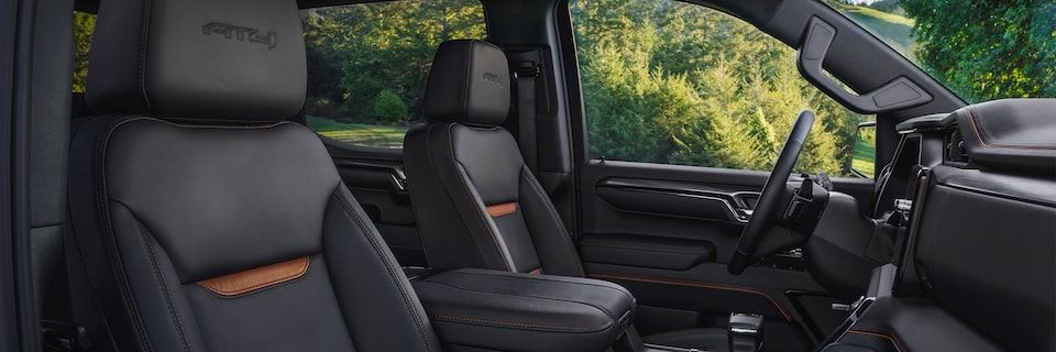 Interior Shot of the 2024 GMC Sierra LD Viewing the Passenger and Driver Leather Seats