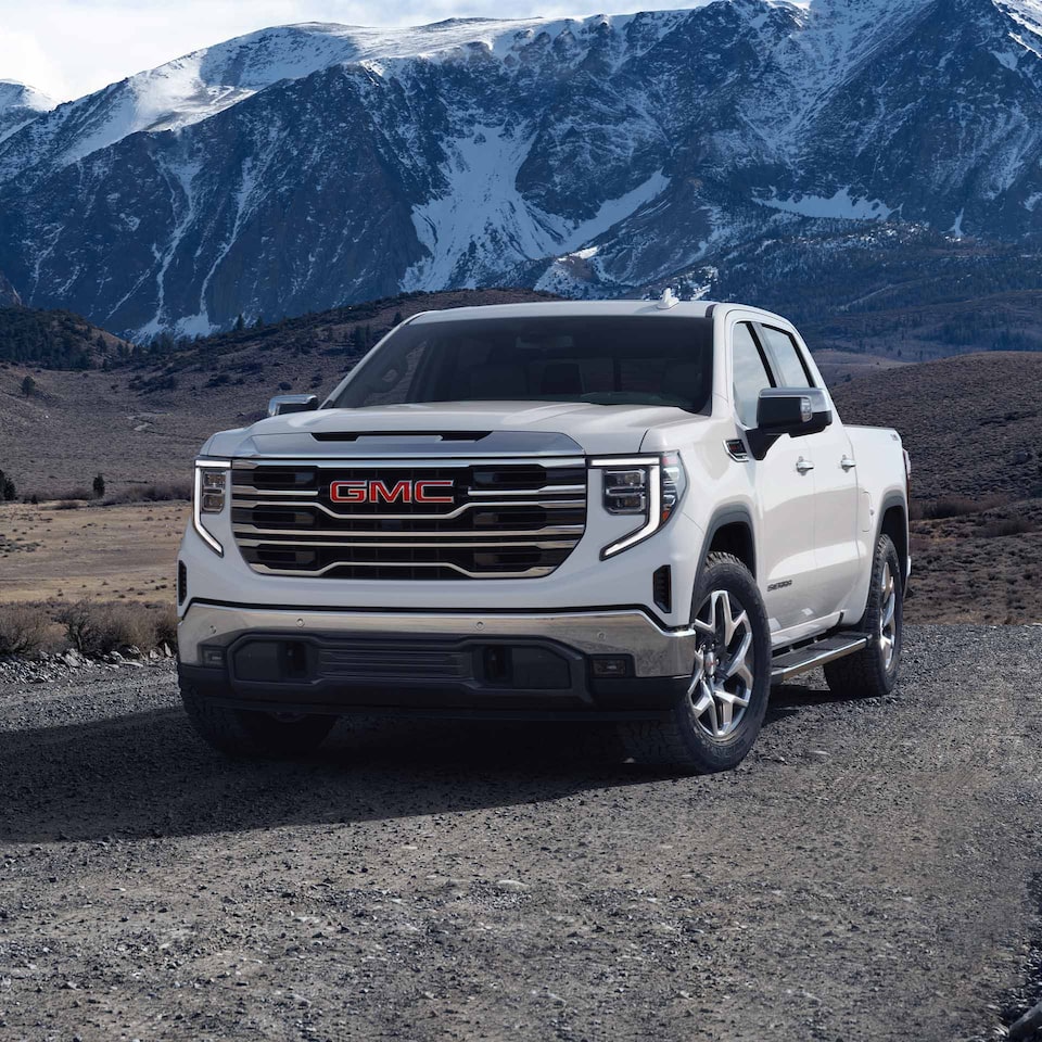 The GMC Sierra LD in White Parked Off-Road in a Valley