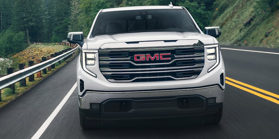 A White 2024 GMC Sierra 1500 SLE Driving On-Road