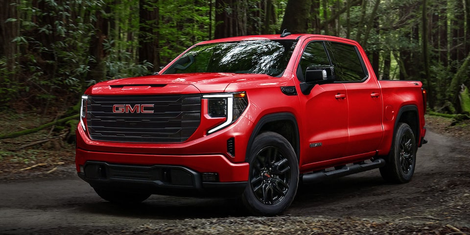 A Red 2024 GMC Sierra 1500 SLE Parked in the Forest