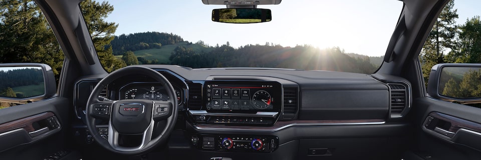 An Interior Front View of the 2024 GMC Sierra 1500 SLE Dashboard with Steering Wheel