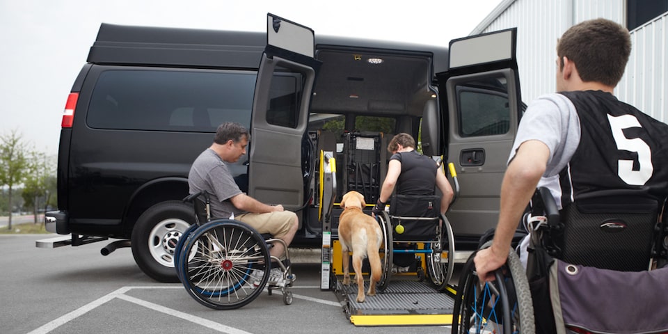 People in Wheelchairs Getting into a Savana Passenger Van