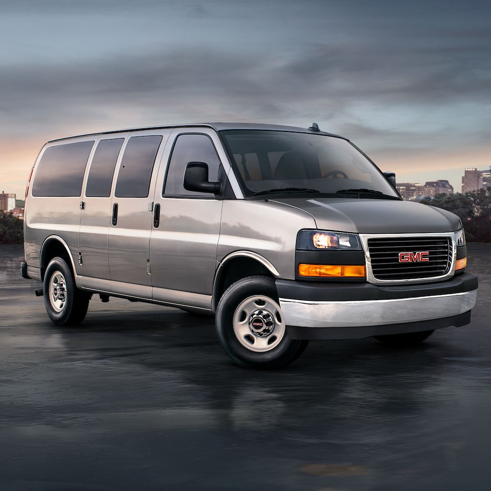The Parked GMC Savana Passenger Near a City